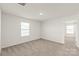 Bright bedroom featuring neutral carpet, ceiling fan, and large windows at 7324 Teague Dr, Gastonia, NC 28056
