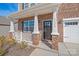Charming front porch with brick columns, a white railing, black front door and manicured landscaping at 7324 Teague Dr, Gastonia, NC 28056