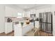 Well-lit kitchen featuring stainless steel appliances, an island, and ample counter space at 7324 Teague Dr, Gastonia, NC 28056