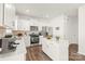 Modern kitchen with white cabinets, stainless steel appliances, hardwood floor and an island at 7324 Teague Dr, Gastonia, NC 28056