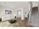 Bright living room with hardwood floors, white walls, area rug, a couch, and view to the dining room at 7324 Teague Dr, Gastonia, NC 28056