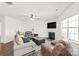 Comfortable living room with neutral tones, a ceiling fan, fireplace, and hardwood floors at 7324 Teague Dr, Gastonia, NC 28056