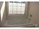 Bathroom featuring a large bathtub and window with blinds at 843 Fairway Dr # 44, Kannapolis, NC 28081