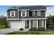 Two-story house with gray siding, white trim, and a two-car garage at 1016 Farm Branch Ct, Indian Trail, NC 28079