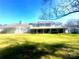 Backyard view showcasing a covered patio and green lawn surrounding the property at 1017 21St Ne Ave, Hickory, NC 28601