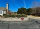 Community entrance with manicured landscaping and 