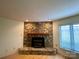 Close-up of the living room's stone fireplace with a wooden mantle at 1017 21St Ne Ave, Hickory, NC 28601