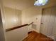 Hallway with chandelier, hardwood floors, stairway, and white door leading to the outside at 1017 21St Ne Ave, Hickory, NC 28601