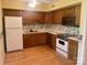 Kitchen with appliances, wood cabinets, and floral wallpaper at 1017 21St Ne Ave, Hickory, NC 28601