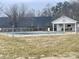 Community pool area showcasing pool cover, clubhouse, and surrounding trees at 1017 21St Ne Ave, Hickory, NC 28601