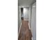 Basement hallway with wood-look flooring, leading to bathroom and storage at 1050 21St Nw Ave # 70, Hickory, NC 28601