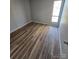 Simple bedroom with wood-look flooring and large window at 1050 21St Nw Ave # 70, Hickory, NC 28601