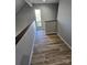 Upper hallway with wood-look floors and window at 1050 21St Nw Ave # 70, Hickory, NC 28601