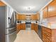 Stainless steel appliances and wood cabinets in this kitchen at 10513 Danesway Ln, Cornelius, NC 28031