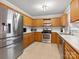 Kitchen with stainless steel appliances and wood cabinets at 10513 Danesway Ln, Cornelius, NC 28031