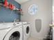 Laundry room with washer, dryer, and ample storage at 10513 Danesway Ln, Cornelius, NC 28031