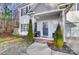 Inviting front porch with brick steps, two chairs, and landscaping at 1110 Kirkland Ct, Concord, NC 28025