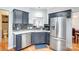 Modern kitchen featuring stainless steel appliances and dark gray cabinetry at 1110 Kirkland Ct, Concord, NC 28025