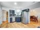 Modern kitchen with dark cabinets, stainless steel appliances, and white countertops at 1110 Kirkland Ct, Concord, NC 28025