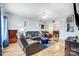 Spacious living room with leather furniture, hardwood floors, and a view into the dining area at 1110 Kirkland Ct, Concord, NC 28025