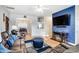 Living room with fireplace, leather furniture, and a large TV at 1110 Kirkland Ct, Concord, NC 28025