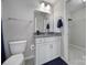 The bathroom features a gray countertop, white cabinetry, and a full-size mirror at 1169 Hollis Sw Cir, Concord, NC 28025