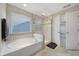 Beautiful bathroom featuring a separate shower and soaking tub with tile surround and nice window light at 1169 Hollis Sw Cir, Concord, NC 28025