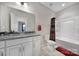 Bright bathroom featuring a granite vanity top, a large mirror, and a shower/tub at 1169 Hollis Sw Cir, Concord, NC 28025