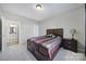 Comfortable bedroom featuring a dark wood bed frame with built in storage and a nightstand at 1169 Hollis Sw Cir, Concord, NC 28025