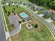 Aerial view of community featuring pool, playground, parking, and green spaces in a residential area at 1169 Hollis Sw Cir, Concord, NC 28025