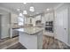 A modern kitchen featuring an island with granite countertops and stainless steel appliances at 1169 Hollis Sw Cir, Concord, NC 28025