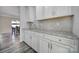 Charming kitchen featuring white cabinets, granite countertops, and a stylish backsplash at 1169 Hollis Sw Cir, Concord, NC 28025