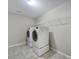 Convenient laundry room with modern washer and dryer set and built-in shelving for organized storage at 1169 Hollis Sw Cir, Concord, NC 28025