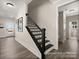 Modern staircase with black metal railing leading to the upper level at 118 Ryan Ln # 7139, Mooresville, NC 28115