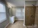 Tiled bathroom with shower, single sink vanity, and bright natural light from the window at 1404 Linwood Rd, Gastonia, NC 28052