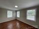 Cozy bedroom with hardwood floors, gray walls, natural light, and recessed lighting at 1404 Linwood Rd, Gastonia, NC 28052