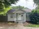 Charming single-story home with a covered front porch, white columns, and a well-maintained front yard at 1404 Linwood Rd, Gastonia, NC 28052