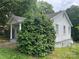 Charming home with white siding, mature shrubbery, and covered front porch at 1404 Linwood Rd, Gastonia, NC 28052