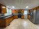 Spacious kitchen with stainless steel appliances, and wooden cabinets, and tile floors under recessed lighting at 1404 Linwood Rd, Gastonia, NC 28052