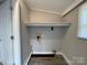 Laundry room with wood-look vinyl floors, shelving and bead board panelling at 1404 Linwood Rd, Gastonia, NC 28052