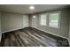 Bright living room with modern gray wood flooring, freshly painted walls, and plenty of natural light at 1404 Linwood Rd, Gastonia, NC 28052