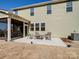 View of the home's backyard featuring a cozy patio with outdoor seating at 14106 Magnolia Walk Dr, Huntersville, NC 28078