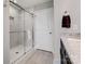 Bathroom features a glass shower with white marbled tile and a white door at 14106 Magnolia Walk Dr, Huntersville, NC 28078