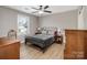 Bedroom featuring wood floors, two windows and a metal bed frame at 14106 Magnolia Walk Dr, Huntersville, NC 28078