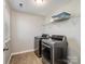 Laundry room features modern washer and dryer and wire shelving at 14106 Magnolia Walk Dr, Huntersville, NC 28078