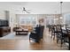 Bright living room open to dining area, featuring large windows and wood floors at 14106 Magnolia Walk Dr, Huntersville, NC 28078