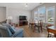 Bright upstairs living area with vaulted ceiling, wood floors, and a TV at 14106 Magnolia Walk Dr, Huntersville, NC 28078