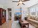 Cozy living room features wood floors, a ceiling fan, and lots of natural light at 14106 Magnolia Walk Dr, Huntersville, NC 28078