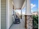 Relaxing front porch with rocking chairs, stone columns, and views of the surrounding neighborhood at 14106 Magnolia Walk Dr, Huntersville, NC 28078