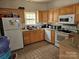 Kitchen with light wood cabinets, appliances, and tile flooring at 1657 Diary Dr, Rock Hill, SC 29732